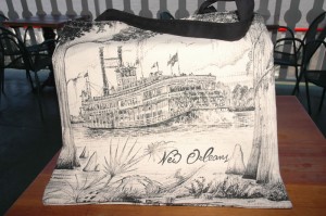 Charcoal black & white tote bag with the NATCHEZ among cypress trees and hanging moss
